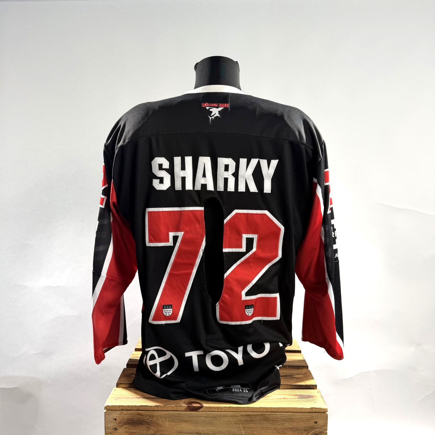 hockey jersey, black jersey, red accents, number 72, player name SHARKY